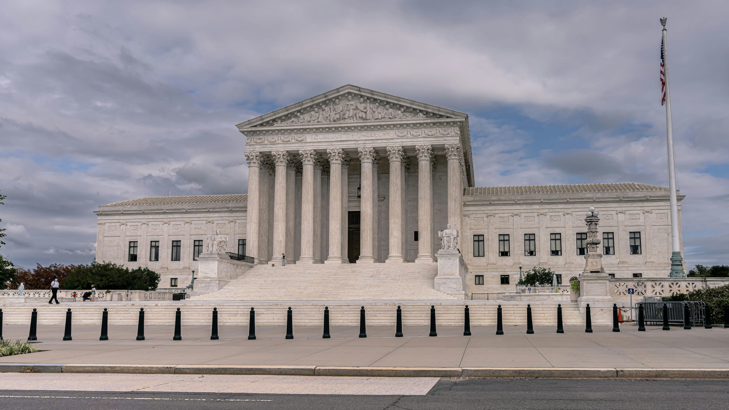 The United States Supreme Court building under cloudy skies