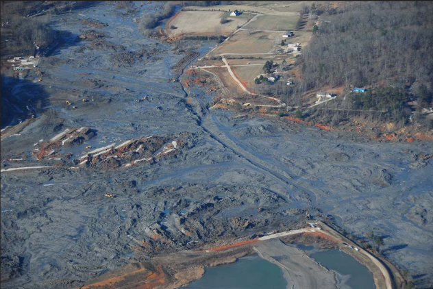 Aerial view of the Kingston Fossil Plant coal ash spill showing 300 acres of land covered in gray coal ash slurry next to the power plant and river
