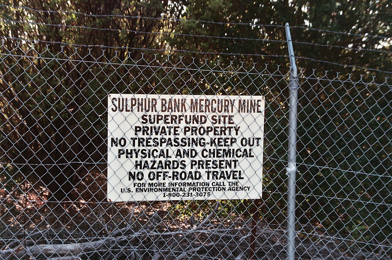 EPA Superfund site warning sign on chain-link fence at Sulphur Bank Mercury Mine